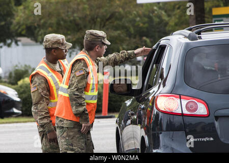 South Carolina National Guard Soldiers from B Battery, 1st of the 178th Field Artillery work with South Carolina Highway Patrol officers at a traffic control point in Conway, S.C. during the lane reversal of Highway 501 in support of the Myrtle Beach area evacuation to safeguard the citizens of the state in advance of Hurricane Florence, on September 11, 2018. Approximately 2,000 Soldiers and Airmen have been mobilized to prepare, respond and participate in recovery efforts for Hurricane Florence, a Category 4 storm, with a projected path to make landfall along the Carolinas and east coast. Ph Stock Photo