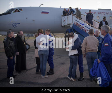 Expedition 57 Flight Engineer Alexey Ovchinin of Roscosmos, left, and Flight Engineer Nick Hague of NASA, right. embrace their families after landing at the Krayniy Airport, on October 11, 2018, in Baikonur, Kazakhstan. Hague and Ovchinin arrived from Zhezkazgan after Russian Search and Rescue teams brought them from the Soyuz landing site. During the Soyuz MS-10 spacecraft's climb to orbit, an anomaly occurred, resulting in an abort downrange. The crew was quickly recovered and is in good condition. NASA Photo by Bill Ingalls/UPI Stock Photo