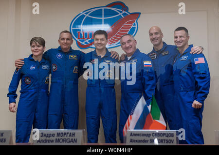 Expedition 58 prime crew members, left to right, Flight Engineer Anne McClain of NASA, Flight Engineer David Saint-Jacques of the Canadian Space Agency (CSA), and Soyuz Commander Oleg Kononenko of Roscosmos, pose for a photo with backup crew members Soyuz Commander Alexander Skvortsov of Roscosmos, Flight Engineer Luca Parmitano of ESA (European Space Agency), and Flight Engineer Andrew Morgan of NASA at the conclusion of a press conference, on December 2, 2018, at the Cosmonaut Hotel in Baikonur, Kazakhstan. Launch of the Soyuz rocket is scheduled for December 3 and will carry Kononenko, McCl Stock Photo