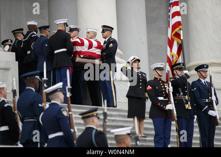 A joint service honor guard carries the casket of former US President George H.W. Bush out of the US Capitol in Washington, DC, on December 5, 2018. George H.W. Bush, the 41st President of the United States (1989-1993), died at the age of 94 on  November 30, 2018 at his home in Texas.     Photo by Shawn Thew/UPI Stock Photo