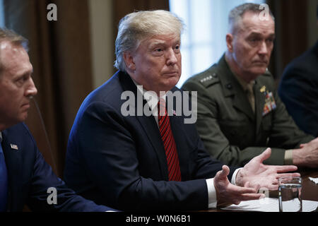 US President Donald J. Trump (C), with Acting Secretary of Defense Patrick Shanahan (L) and Chairman of the Joint Chiefs of Staff General Joseph Dunford (R), delivers remarks during a briefing by senior military leaders in the Cabinet Room of the White House in Washington, DC on April 3, 2019. Following the briefing President Trump will host a dinner for the officials.   Photo by Shawn Thew/UPI Stock Photo