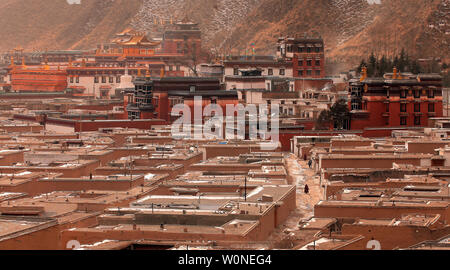A lone Tibetan monk walks through a maze of alleys at the Labrang Monastery, the largest Tibetan monastery outside of Lhasa, during the Tibetan Monlam Festival in Xiahe, a small town in Gansu Province on the Tibetan plateau, February 5, 2012.  China on Monday warned government officials in Tibet that failing to maintain stability could result in job loss or criminal prosecution, the latest sign of increasing ethnic tensions between Tibetans and the Chinese government.   UPI/Stephen Shaver Stock Photo
