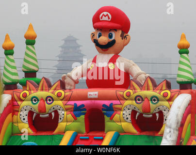 A Super Mario inflatable slide sits under heavy pollution near a Chinese temple in Baoji city in China's central Shaanxi Province on April 8, 2015.  China's top leaders have made reducing air pollution a top priority as the country faces major environmental challenges due to its unbridled economic growth over the last two decades.        Photo by Stephen Shaver/UPI Stock Photo