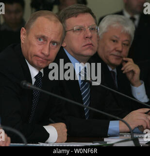 Russian President Vladimir Putin (L) and Russian Finance Minister Alexei Kudrin (C) attend a meeting with local government officials of the republic of Yakutia (Sakha) to discuss the republic's social and economic development in the Siberian city of Yakutsk, January 6, 2006. (UPI Photo/Anatoli Zhdanov) Stock Photo