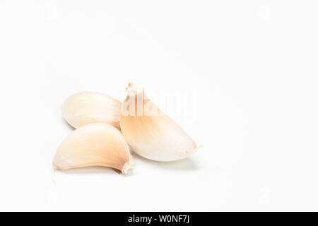 Peeled garlic and complete garlic against a white background Stock Photo