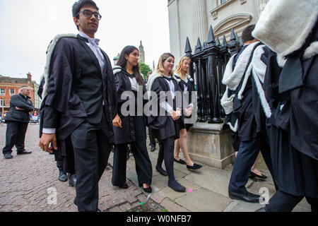 Cambridge University students from St John's College on the first day of this years graduation ceremonies at the Senate House.  Students dressed in black gowns as the traditional Cambridge University graduation ceremonies took place today (Wed).  The students paraded into historic Senate House watched by family and friends to collect their degrees from the prestigious university.  Many parts of the degree ceremonies, which will also be held over the next few days, have their origin amongst the earliest customs of the university 800 years ago.  Undergraduates are required to wear the gown of th Stock Photo