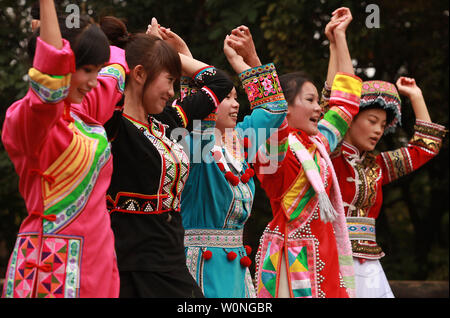 Chinese women of the ethnic minority group the Lahu sing and dance to traditional songs during a show for tourists in the Yunnan Nationalities Village in Kunming, the capital of China's southern Yunnan Province, on September 23, 2012. China recognizes 55 ethnic minority groups within the country in addition to the Han majority.  With over 25 ethnic minorities living in Yunnan, they make up about 34 percent of its population.  All are hanging on their cultural identity as 'progress' is accompanied by a larger, more powerful Han majority.      UPI/Stephen Shaver Stock Photo