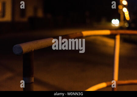 old red-white railing at night by the road Stock Photo