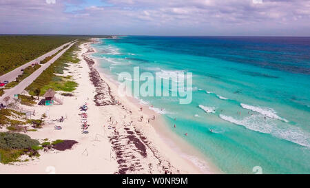 Overhead drone shot of swimmers on a tropical beach in Cozumel, Mexico. Stock Photo