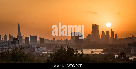 London, UK. 27th June, 2019. UK Weather: Dramatic sunset from the top of Greenwich Park as a city heatwave begins with temperatures predicted to exceed 31C over the coming days. Credit: Guy Corbishley/Alamy Live News Stock Photo