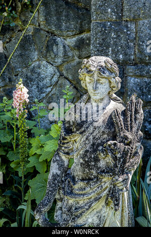 A statue of a woman in the Hatley Castle garden in Victoria BC, Canada. Stock Photo