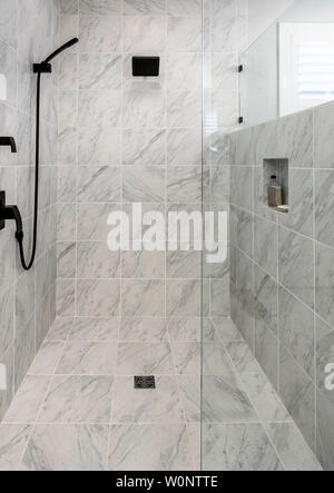 Luxury wheelchair accessible shower with marble floor and walls. Stock Photo