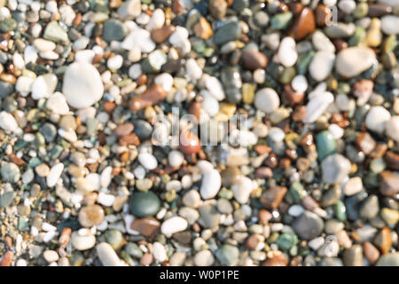 Blurred colorful small sea stone pebble background. Multicolored abstract beach nature pattern Stock Photo