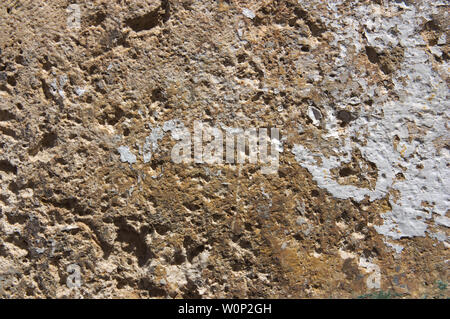 Close-up of a rugged brown textured wall illuminated by the sun Stock Photo