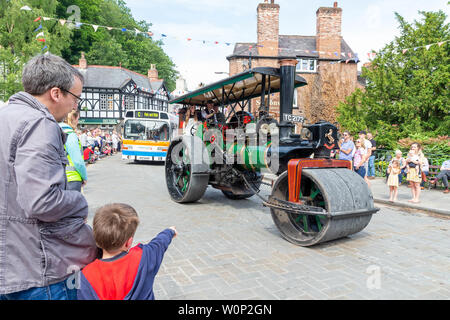 Line of steam rollers of varying sizes in the Lymm Historic Transport parade through the village streets Stock Photo
