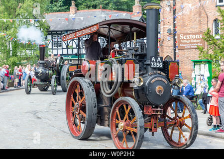 Line of steam rollers of varying sizes in the Lymm Historic Transport parade through the village streets Stock Photo