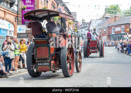 Line of steam rollers of varying sizes in the Lymm Historic Transport parade through the village streets Stock Photo