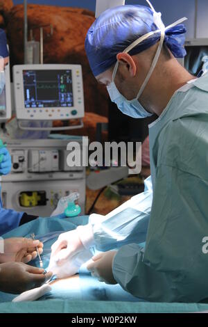 doctors and nurses preforming surgery Stock Photo