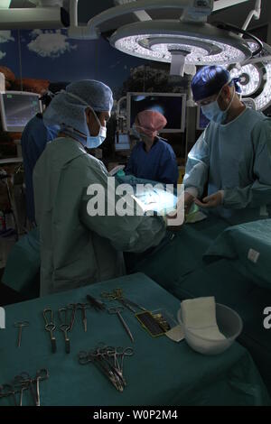 doctors and nurses preforming surgery Stock Photo