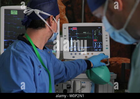 doctors and nurses preforming surgery Stock Photo