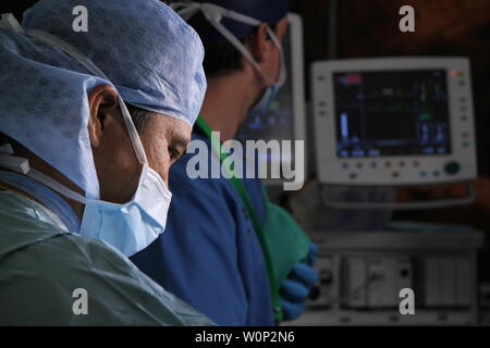 doctors and nurses preforming surgery Stock Photo