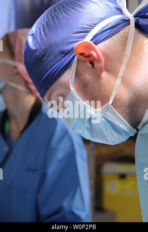 doctors and nurses preforming surgery Stock Photo