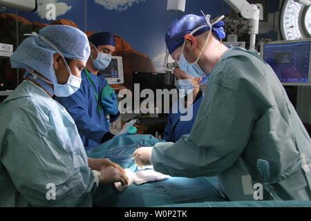 doctors and nurses preforming surgery Stock Photo