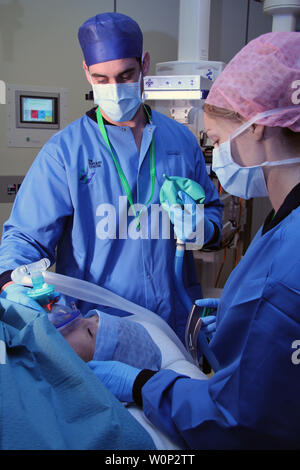 doctors and nurses preforming surgery Stock Photo