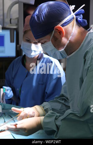 doctors and nurses preforming surgery Stock Photo