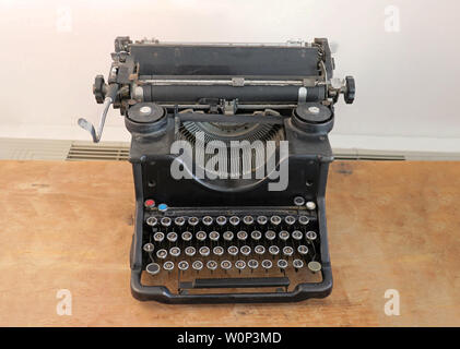 Old retro manual typewriter machine on wooden table Stock Photo