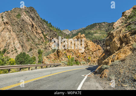 Two-lane winding road through the Wasatch Mountains in Utah with just a hint of fall here and there. Stock Photo