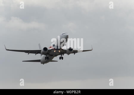 DENPASAR,BALI/INDONESIA-JUNE 08 2019: Malaysia Airline is taking off from Ngurah Rai International Airport Bali runway, when the sky is cloudy grey Stock Photo