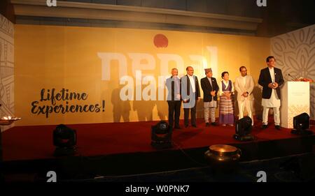 Kathmandu, Nepal. 27th June, 2019. Nepal's Secretary at the Ministry of Culture, Tourism and Civil Aviation Mohan Krishna Sapkota (3rd L) and Suraj Vaidhya (R), national coordinator of Visit Nepal Year 2020, unveil the official brand logo of Visit Nepal Year 2020 in Kathmandu, Nepal, on June 27, 2019. Nepal is marking 2020 as Visit Nepal Year with a target of boosting local tourism. Credit: Sunil Sharma/Xinhua/Alamy Live News Stock Photo