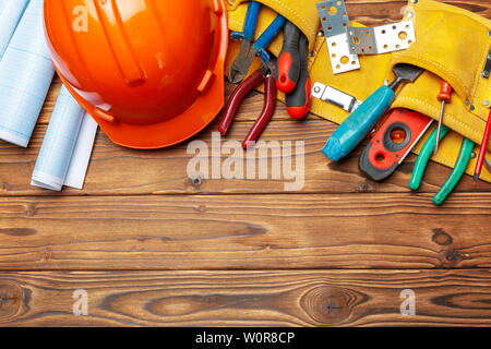 Assorted work tools on wooden table Stock Photo