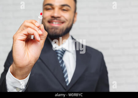 Close up of businessman hand with pen ready to write something in the office Stock Photo