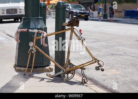 An old broken racing bicycle without wheels on a street of Manhattan, New York, USA. Stock Photo