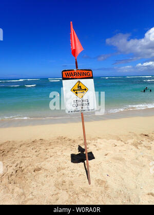 Waikiki Beach with Warning Strong Current Sign on Oahu, Hawaii on June 12, 2016. Stock Photo
