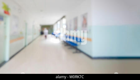 Blurred unfocused view of interior hallway and waiting room of children hospital - Out of focus blur shot background backdrop of clinic medical instit Stock Photo