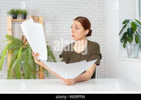 Female office workers holding are arranging documents of unfinished documents on office desk Stock Photo