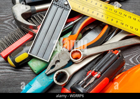 Assorted work tools on wooden table Stock Photo
