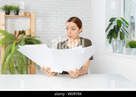 Female office workers holding are arranging documents of unfinished documents on office desk Stock Photo