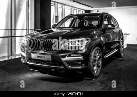 BERLIN - JUNE 09, 2018: Showroom. Compact luxury crossover SUV BMW X3. Black and white. Stock Photo