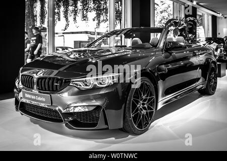 BERLIN - JUNE 09, 2018: Showroom. Compact executive car/Sports car BMW M4 Cabrio. Black and white. Stock Photo