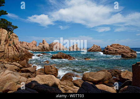 Red rock formation at a beach at Costa Paradiso in Sardinia (Italy) with turquoise blue sea Stock Photo