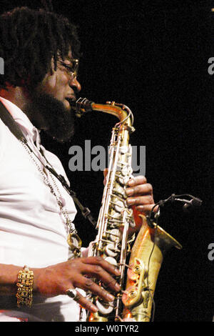 The saxophonist and DJ Soweto Kinch and his band from Birmingham in Great Britain played a concert in the NaTo on the occasion of the 42nd Leipzig Jazztage. The band consists of Soweto Kinch (saxophone, vocals), Nick Jurd (contrabass) and David Hodek (drums). Stock Photo