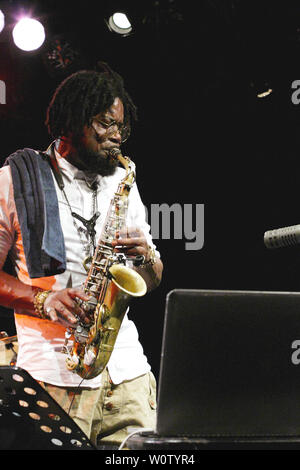 The saxophonist and DJ Soweto Kinch and his band from Birmingham in Great Britain played a concert in the NaTo on the occasion of the 42nd Leipzig Jazztage. The band consists of Soweto Kinch (saxophone, vocals), Nick Jurd (contrabass) and David Hodek (drums). Stock Photo