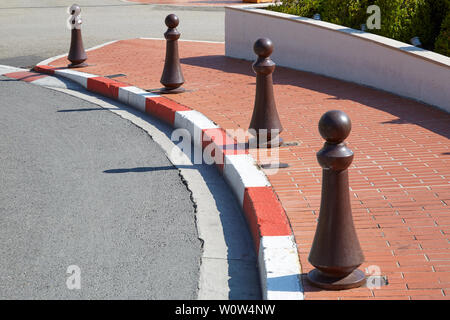 Monte Carlo street curve with formula one red and white signs in a sunny summer day in Monte Carlo, Monaco. Stock Photo