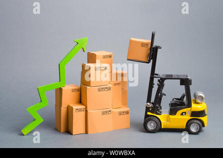 Forklift truck raises cardboard boxes on a yellow background. Cargo ...