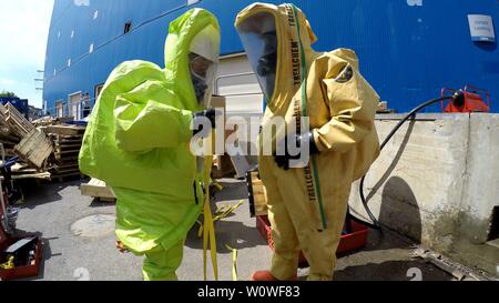 Firefighters seal leak of hazardous corrosive toxic materials from barrels after rocket attack during drill called Northern Face, MIGDAL HAEMEK, ISRAEL, MARCH 23, 2015. Stock Photo