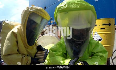 Firefighters seal leak of hazardous corrosive toxic materials from barrels after rocket attack during drill called Northern Face, MIGDAL HAEMEK, ISRAEL, MARCH 23, 2015. Stock Photo